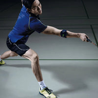 Badmintonspelare med Bauerfeind Sports Elbow Strap på armen